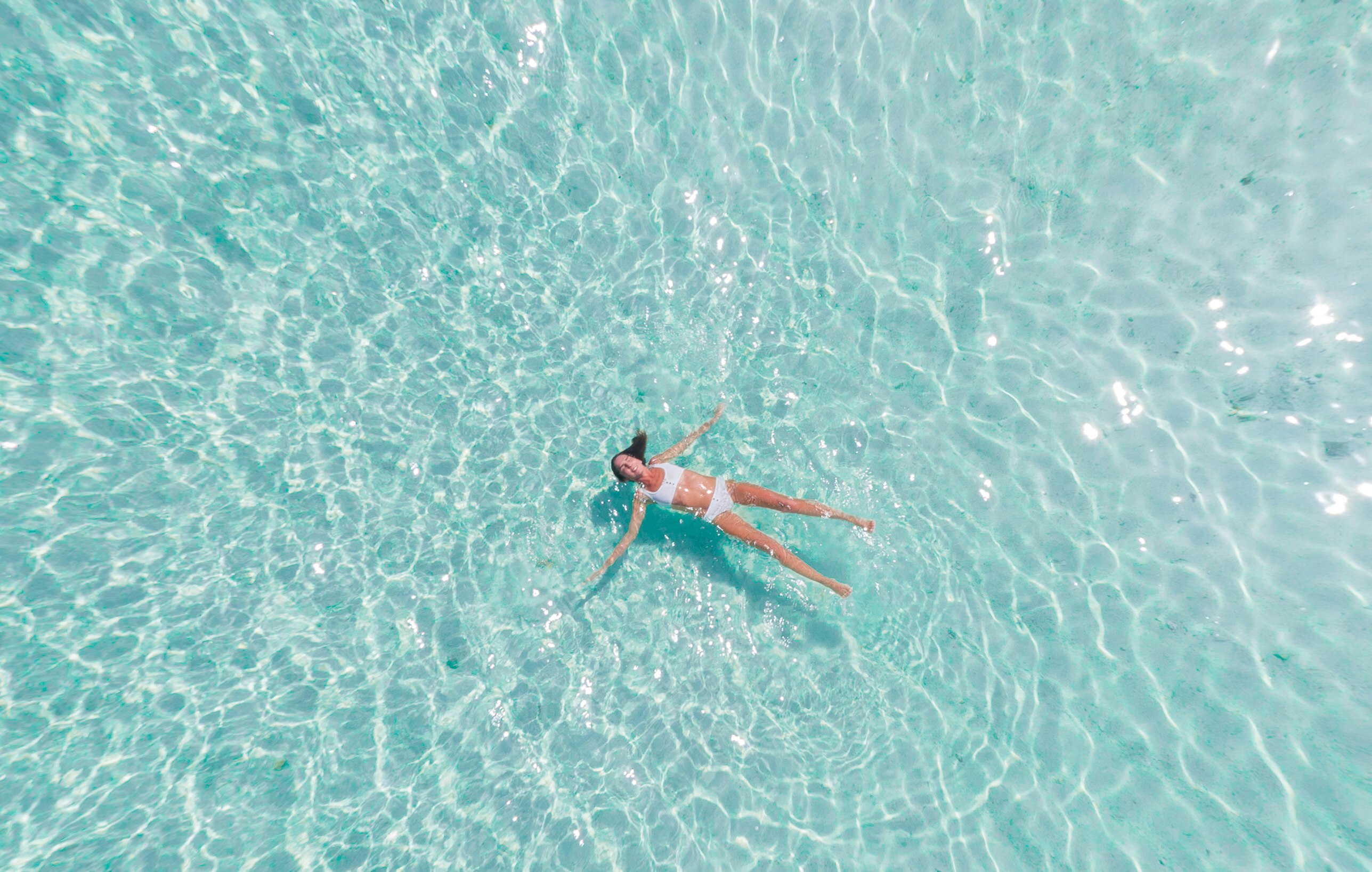 woman swimming on body of water